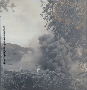 The ship burning after it was bombed (Photograph by Eugene McGraw)